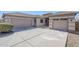 Inviting single-story home showcasing a tandem three-car garage and low-maintenance desert landscaping at 43205 W Oster Dr, Maricopa, AZ 85138