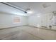 Spacious garage with concrete flooring, natural light from a window, and a water heater at 43205 W Oster Dr, Maricopa, AZ 85138