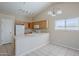 Kitchen with a breakfast bar, tile flooring, and white appliances next to a dining area at 43205 W Oster Dr, Maricopa, AZ 85138