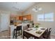 Bright kitchen featuring a dining table, marble countertop, and stainless steel appliances at 43205 W Oster Dr, Maricopa, AZ 85138