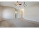 Open concept living room featuring tile flooring and carpet, neutral walls, and vaulted ceiling at 43205 W Oster Dr, Maricopa, AZ 85138