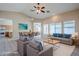 Virtually staged living room and dining area showcasing ample natural light, neutral walls and modern décor at 43205 W Oster Dr, Maricopa, AZ 85138