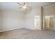 Bright, airy bedroom with neutral walls, high ceilings, and doorways to the bathroom and closet at 43205 W Oster Dr, Maricopa, AZ 85138