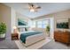 Comfortable bedroom with modern furnishings, including plants, soft bedding, and bright windows at 43205 W Oster Dr, Maricopa, AZ 85138