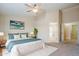 Inviting bedroom with soft bedding, ambient lighting, and bathroom access, offering a relaxing retreat at 43205 W Oster Dr, Maricopa, AZ 85138