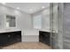 Bathroom featuring dual vanities, soaking tub, and glass-enclosed tiled shower at 4853 N 183Rd Ln, Goodyear, AZ 85395