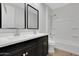 Bathroom featuring double vanity with framed mirror and shower-tub combo at 4853 N 183Rd Ln, Goodyear, AZ 85395