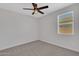 Neutral bedroom with soft carpeting, ceiling fan, and a sunlit window at 4853 N 183Rd Ln, Goodyear, AZ 85395