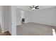 Spacious bedroom with neutral carpet and a ceiling fan, leading to bathroom at 4853 N 183Rd Ln, Goodyear, AZ 85395