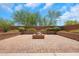 Paver-covered courtyard features a built-in brick fire pit, providing a cozy and inviting outdoor space at 4853 N 183Rd Ln, Goodyear, AZ 85395