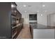 Modern kitchen with a central island, stainless steel appliances, and sleek, dark cabinetry offering ample storage at 4853 N 183Rd Ln, Goodyear, AZ 85395