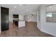 Bright and spacious living area that seamlessly connects to the kitchen with a large island and stainless appliances at 4853 N 183Rd Ln, Goodyear, AZ 85395