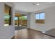 Bright room with wood floors, sliding glass doors to patio, and large windows at 4853 N 183Rd Ln, Goodyear, AZ 85395
