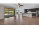 Open living space with a sliding glass door to the backyard and a view of a modern kitchen at 4853 N 183Rd Ln, Goodyear, AZ 85395