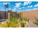 Backyard featuring a basketball hoop, brick walls, and small garden space at 4960 E Colonial Dr, Chandler, AZ 85249