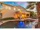 Spacious backyard with a pool, covered patio, fire pit, and outdoor living spaces at 4960 E Colonial Dr, Chandler, AZ 85249