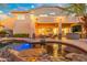 Beautiful backyard featuring a pool, covered patio with a fireplace, and ample seating for entertaining at 4960 E Colonial Dr, Chandler, AZ 85249