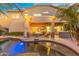 Lovely backyard showcasing a pool, covered patio with fire pit, and an outdoor kitchen at 4960 E Colonial Dr, Chandler, AZ 85249