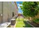 Side yard lawn area with mature trees, gravel area, and fencing; utility boxes in view at 4960 E Colonial Dr, Chandler, AZ 85249