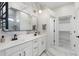 Elegant bathroom features a double vanity, a large mirror, and modern lighting fixtures at 4960 E Colonial Dr, Chandler, AZ 85249