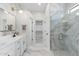 Bright bathroom with double sinks, a walk-in shower with marble tiles, and a spacious walk-in closet at 4960 E Colonial Dr, Chandler, AZ 85249