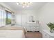 Bright bedroom with a modern chandelier and a window with natural light at 4960 E Colonial Dr, Chandler, AZ 85249