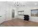 Modern bedroom with natural light features a decorative chandelier and sleek minimalist furniture at 4960 E Colonial Dr, Chandler, AZ 85249