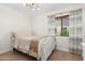 Cozy bedroom featuring neutral tones, a light-colored bed, and a window at 4960 E Colonial Dr, Chandler, AZ 85249