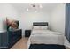 Bedroom with wood flooring, a large bed, and a television on a dresser at 4960 E Colonial Dr, Chandler, AZ 85249