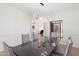 Bright dining room with modern light fixture, table with seating for six, and hardwood floors at 4960 E Colonial Dr, Chandler, AZ 85249