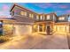 Stunning two-story home with a three-car garage, stone accents, and a well-manicured front yard at 4960 E Colonial Dr, Chandler, AZ 85249