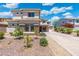 Charming two-story home with stone accents and desert landscaping in front at 4960 E Colonial Dr, Chandler, AZ 85249