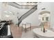 Bright foyer with grand staircase, chandelier, and views to dining and living areas at 4960 E Colonial Dr, Chandler, AZ 85249