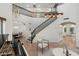 Grand foyer with staircase, piano, modern lighting, and elegant furnishings at 4960 E Colonial Dr, Chandler, AZ 85249