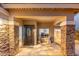 Inviting front entrance with stone pillars, decorative door, and well-manicured landscaping at 4960 E Colonial Dr, Chandler, AZ 85249