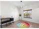 Bright home office with wood-style flooring, a colorful chandelier, and a large window overlooking the front yard at 4960 E Colonial Dr, Chandler, AZ 85249