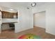Home office area with built-in desk and upper cabinets, a colorful chandelier, and wood-style flooring at 4960 E Colonial Dr, Chandler, AZ 85249