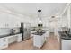 Bright kitchen featuring an island with granite countertops, stainless steel appliances, and white cabinetry at 4960 E Colonial Dr, Chandler, AZ 85249