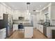 Spacious kitchen boasts stainless steel appliances, white cabinets, and granite countertops at 4960 E Colonial Dr, Chandler, AZ 85249