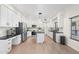 Bright kitchen featuring white cabinets, stainless steel appliances, and an island at 4960 E Colonial Dr, Chandler, AZ 85249