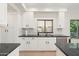 Well-lit kitchen showcasing granite countertops, white cabinets, and modern fixtures at 4960 E Colonial Dr, Chandler, AZ 85249