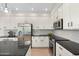 Modern kitchen with stainless steel appliances, white cabinets, and a large island at 4960 E Colonial Dr, Chandler, AZ 85249