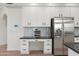 Modern kitchen features stainless steel fridge and white cabinets with black hardware at 4960 E Colonial Dr, Chandler, AZ 85249