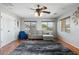 Comfortable living room with a ceiling fan, large rug, and two bright windows at 4960 E Colonial Dr, Chandler, AZ 85249