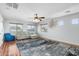 Cozy living room with hardwood floors, ceiling fan, and view of the neighborhood at 4960 E Colonial Dr, Chandler, AZ 85249