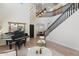 Bright living room featuring a grand piano, modern furnishings, high ceilings and an elegant staircase at 4960 E Colonial Dr, Chandler, AZ 85249
