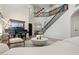 Bright living room featuring a grand piano, modern furnishings, high ceilings and an elegant staircase at 4960 E Colonial Dr, Chandler, AZ 85249