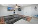 Bright living room boasts hardwood floors, a ceiling fan, a modern area rug, and contemporary art at 4960 E Colonial Dr, Chandler, AZ 85249