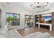 Bright living room with hardwood floors, a stone entertainment center, and sliding doors leading to the backyard at 4960 E Colonial Dr, Chandler, AZ 85249