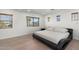 Bright bedroom with large windows, a platform bed, and serene, inviting ambiance at 4960 E Colonial Dr, Chandler, AZ 85249